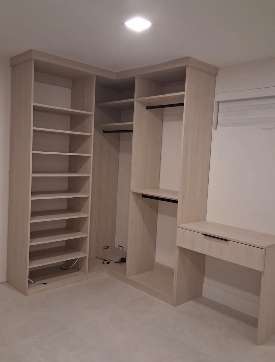 White walk-in closet with open shelving and drawer tower
