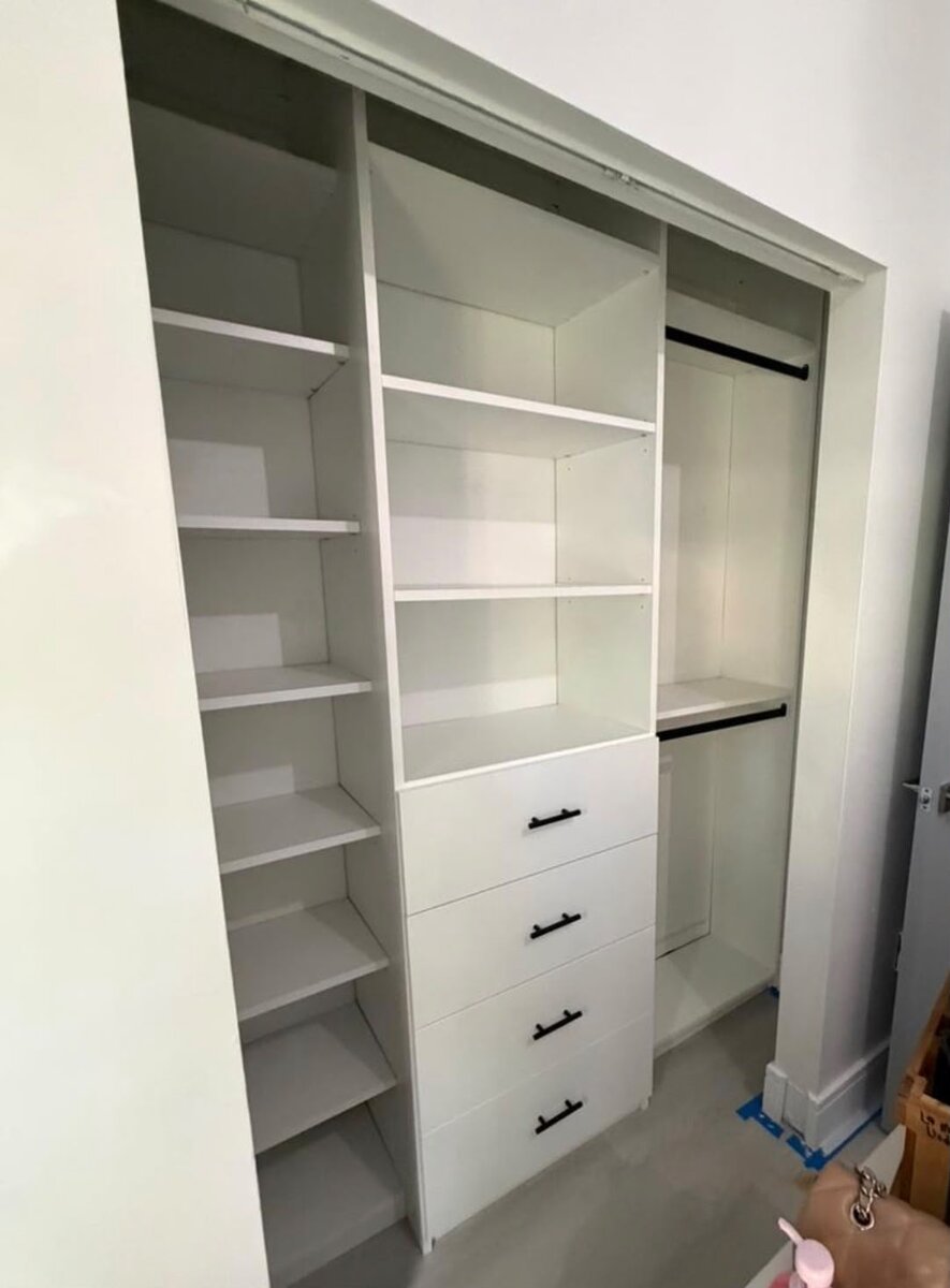 White closet system with black hardware and open shelving