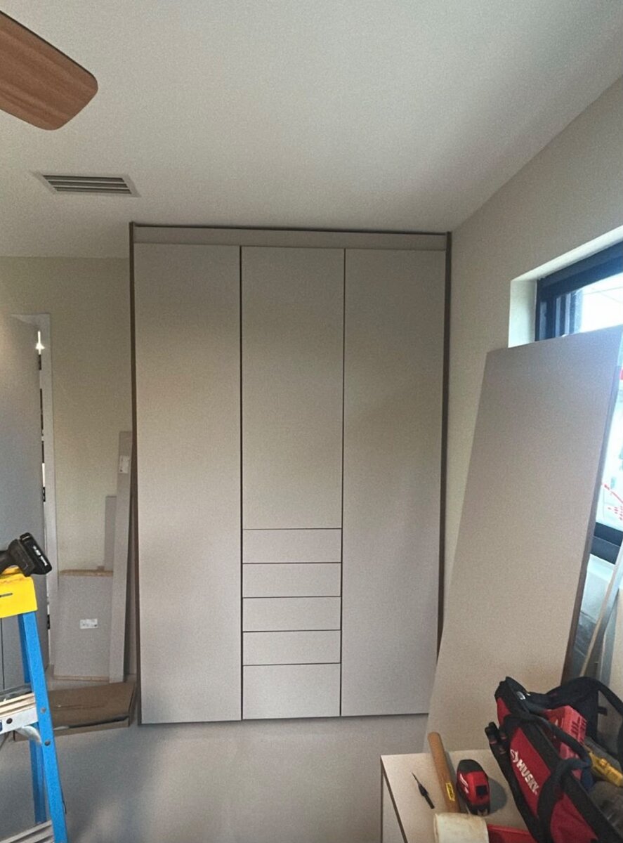 Large white walk-in closet with multiple drawer towers