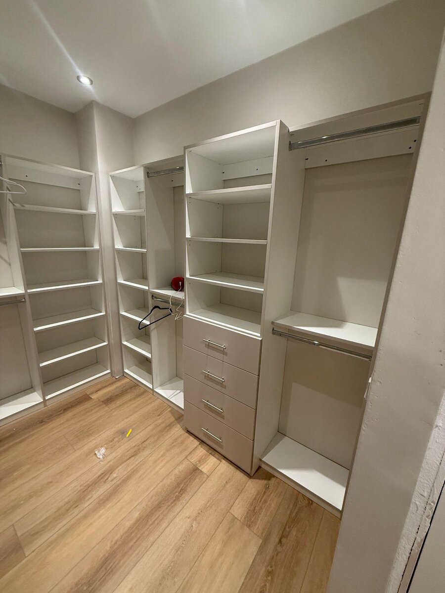 Light wood corner closet with built-in vanity desk