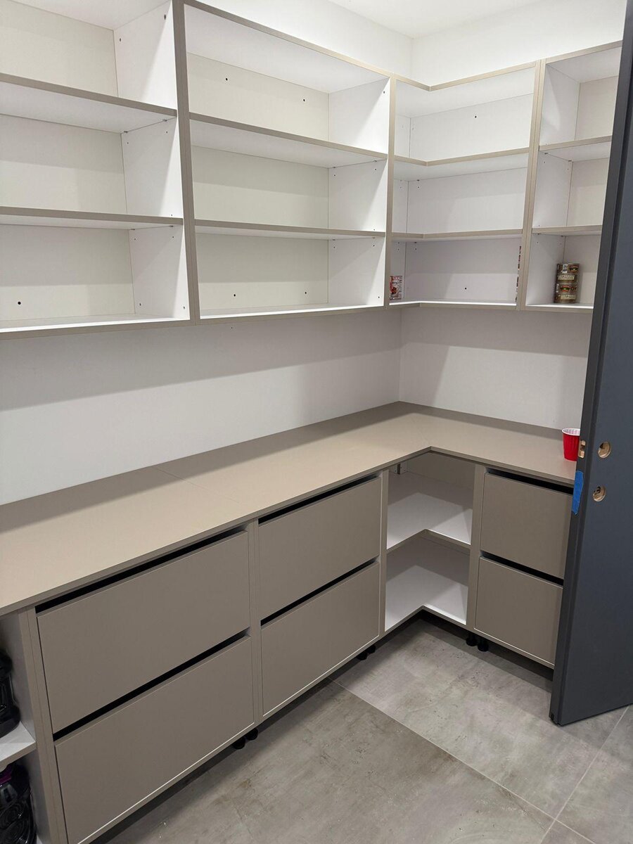 Gray closet system with navy accent shelving and drawers