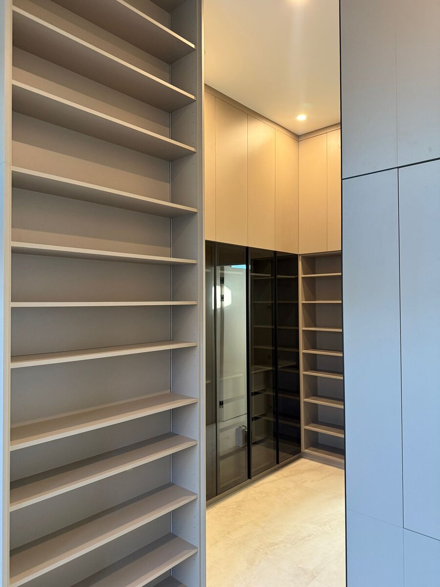 Floor-to-ceiling wardrobe with paneled doors and center drawers