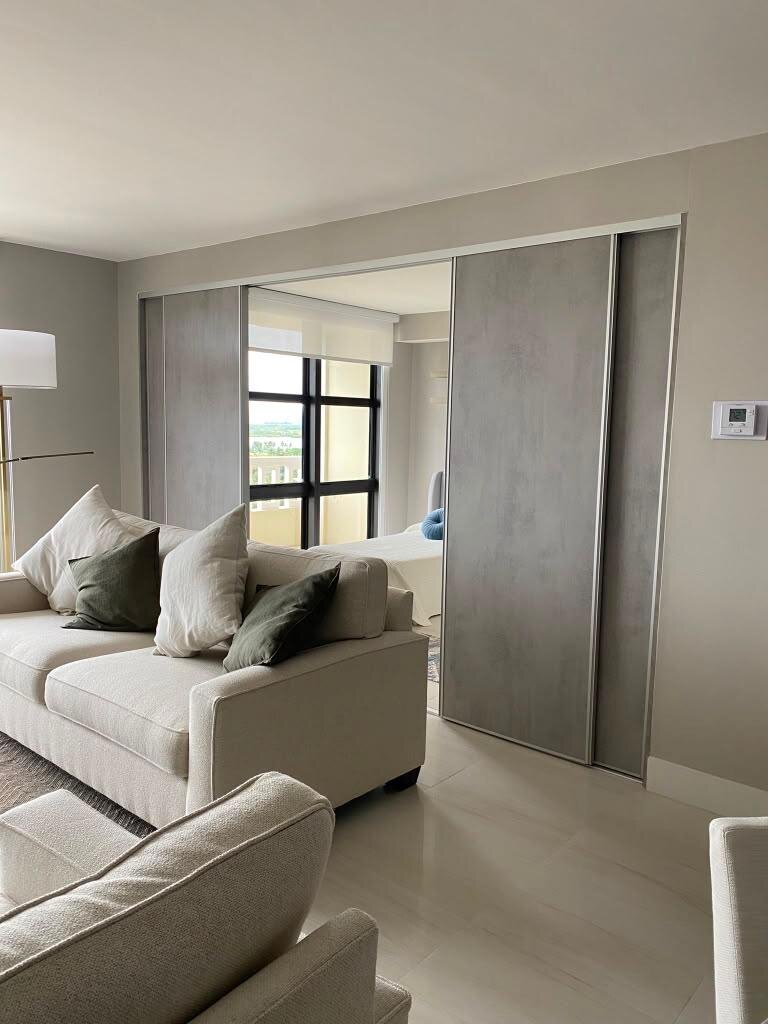 Gray sliding closet doors in a bedroom
