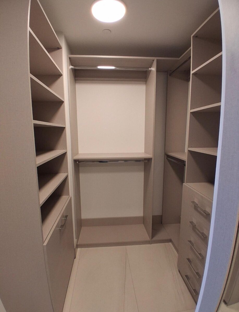 Walk-in closet with open shelving, drawers and hanging storage
