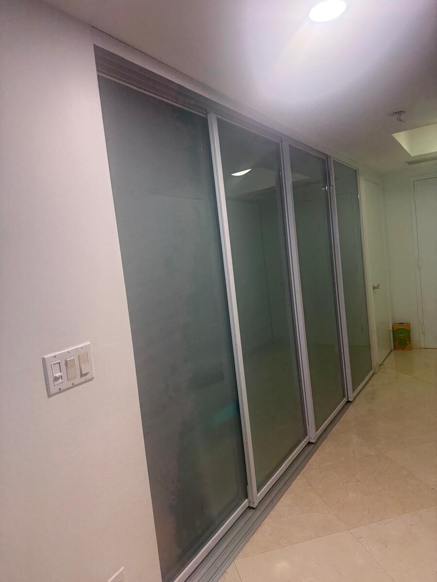 Frosted glass sliding closet doors in a hallway